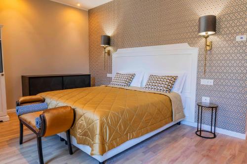 a bedroom with a bed and a chair in it at Liberty Hotel Malé in Malè