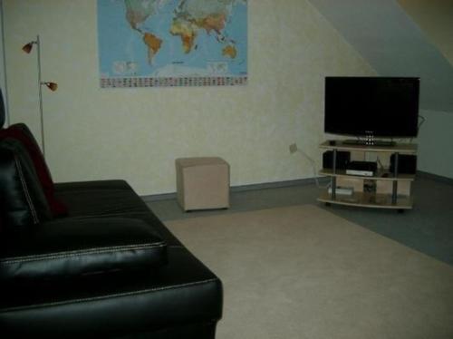 a living room with a couch and a flat screen tv at Wohnung in Castrop-Rauxel mit Garten in Castrop-Rauxel