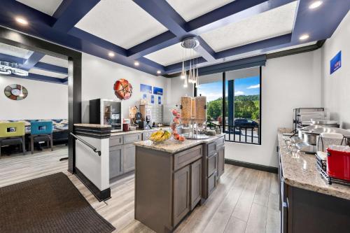 a large kitchen with blue ceilings and a large island at Best Western Corbin Inn in Corbin