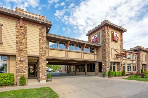 a large building with a walkway in front of it at Best Western Plus Weston Inn in Logan