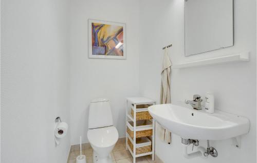 a white bathroom with a sink and a toilet at Beautiful Home In Gråsten With Kitchen in Gråsten