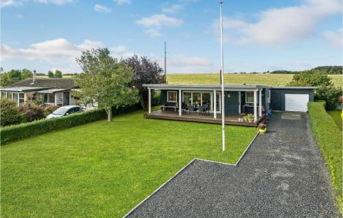 a home with a large yard with a house at Two-Bedroom Holiday Home In Borkop in Børkop