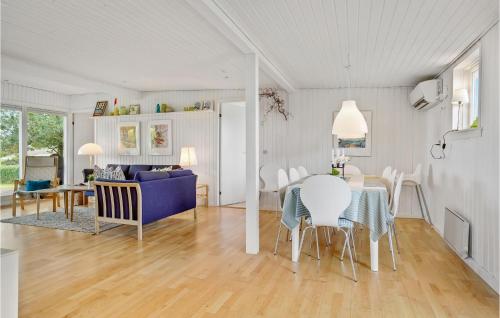a dining room and living room with a table and chairs at Two-Bedroom Holiday Home In Borkop in Børkop