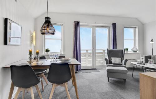 a dining room and living room with a table and chairs at Cozy Apartment In Rudkøbing With Wifi in Rudkøbing