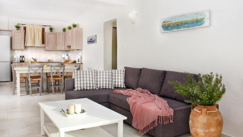 a living room with a couch and a table at Mani Apartments in Agios Nikolaos