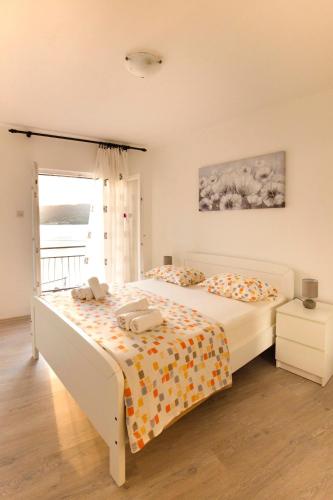 a bedroom with a bed and a window at Apartments by the sea Vis - 8525 in Vis