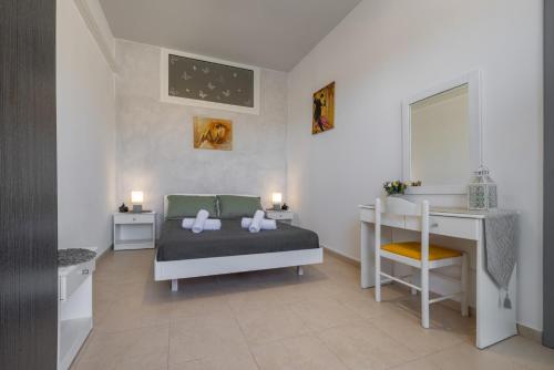 a bedroom with a bed and a desk and a desk at Rania's House Faliraki in Faliraki