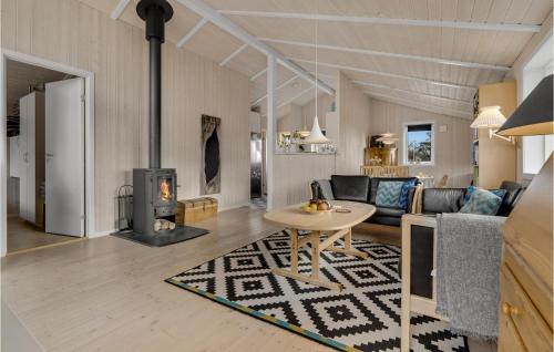 a living room with a table and a fireplace at Cozy Home In Aabenraa With Sauna in Aabenraa