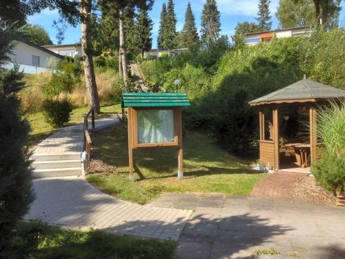 a gazebo and a shelter in a yard at Modern ausgestattetes Ferienhaus mit möblierter Südhang-Terrasse im Altenautal in Husen