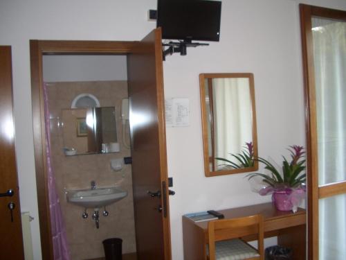 a bathroom with a sink and a mirror at Albergo Il Castellino in Boario Terme