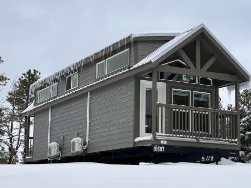 a small house with two chairs in the snow at Cozy cabins by the forest 1B in Williams