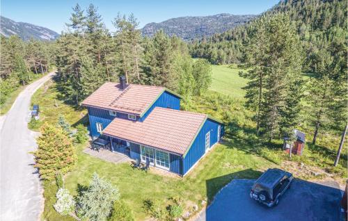 an aerial view of a blue house in the mountains at Bjørnehiet - Hytte 6 in Øvre Ramse