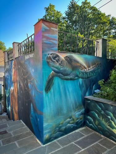 a mural of a sea turtle on a wall at Sunset Cove in East Hampton