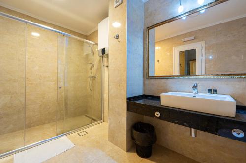 a bathroom with a sink and a shower at Hotel Adrović in Sveti Stefan