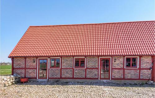 a red building with an orange roof at 3 Bedroom Awesome Home In Viken in Viken
