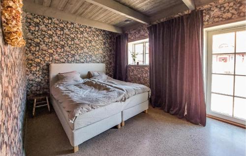a bedroom with a bed in a room at 3 Bedroom Awesome Home In Viken in Viken