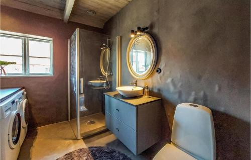a bathroom with a sink and a mirror at 3 Bedroom Awesome Home In Viken in Viken