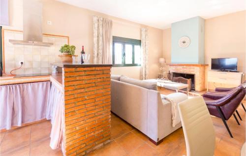 a kitchen and a living room with a couch and a table at Stunning Home In Ubrique With Kitchen in Ubrique