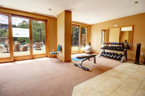 a room with a gym with a lot of exercise equipment at PP403 Passage Point condo in Copper Mountain