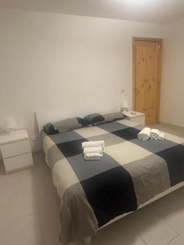 a bedroom with a large bed with towels on it at Villa Jobè in Polignano a Mare