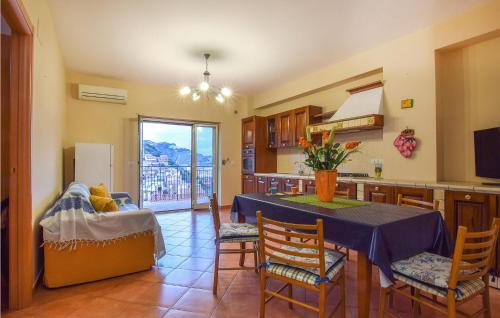 a kitchen with a table and chairs in a room at Awesome Apartment In Giardini Naxos in Giardini Naxos
