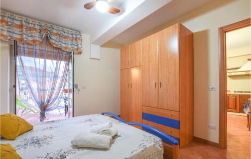 a bedroom with a bed and a large window at Awesome Apartment In Giardini Naxos in Giardini Naxos
