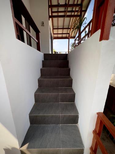 a staircase leading up to a house at Kalamoana House in Gili Trawangan