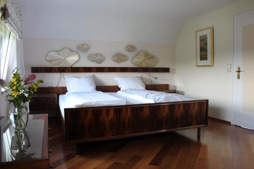 a bedroom with two beds and a vase of flowers at Ferienhaus für 6 Personen ca 126 m in Alsbach, Rhein Mittelrheintal in Alsbach