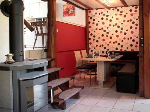 a restaurant with a stove and a table in a room at Familienfreundliches Ferienhaus in Frielendorf in Frielendorf