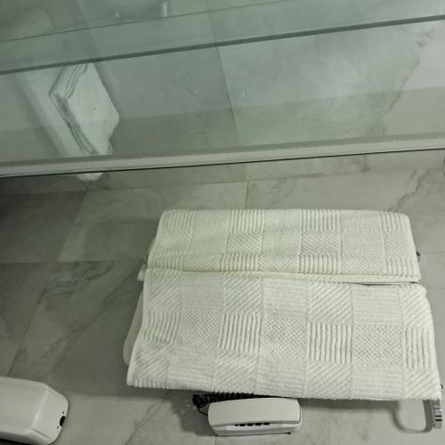 a white towel sitting on a counter in a bathroom at hotel tambau flat particular 605 in João Pessoa