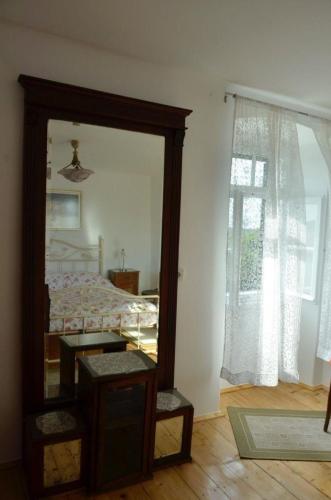 a bedroom with a mirror and a bed and a window at Insel Cres, Stivan, liebevoll restauriertes Dorfhaus über der Adriabucht Merascica in Štivan