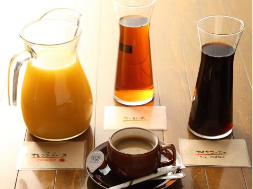 a cup of coffee and two glasses of orange juice at Hotel Century Art in Fukuoka