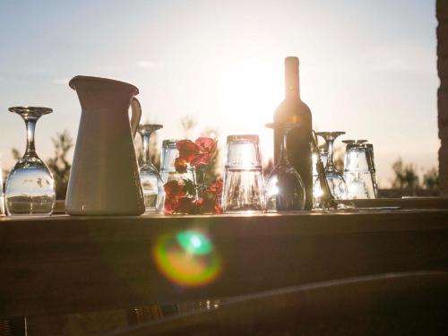 a table with many different types of vases on it at Poliana Estate Villas in Riglia