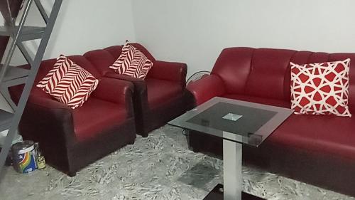 a living room with two couches and a table at Sarah's Garden BnB & BnB Spa Family room with livingroom in Clarin
