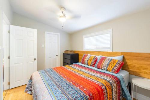 a bedroom with a bed with a wooden headboard at Bunglow in the Bend in Grand Bend
