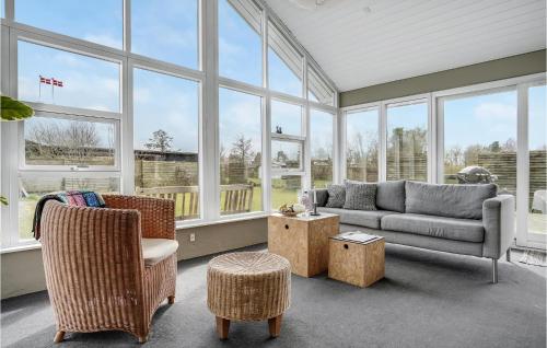 a living room with a couch and chairs and windows at Beautiful Home In Otterup With Kitchen in Otterup