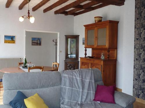 un salon avec un canapé et une table dans l'établissement Maison avec jardin clos et terrasse couverte en Touraine, proche des châteaux et nature préservée. - FR-1-381-574, à Manthelan