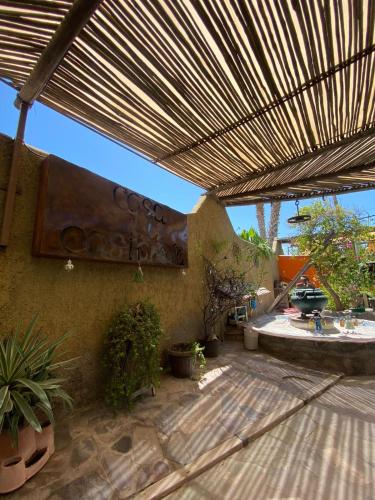 a patio with awning and plants and a fountain at Casa La Castañeda in Loreto