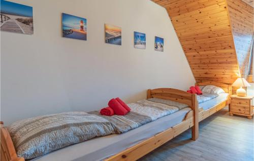 a bedroom with a bed with red pillows on it at Awesome Home In Friedrichskoog-Spitze in Friedrichskoog-Spitz