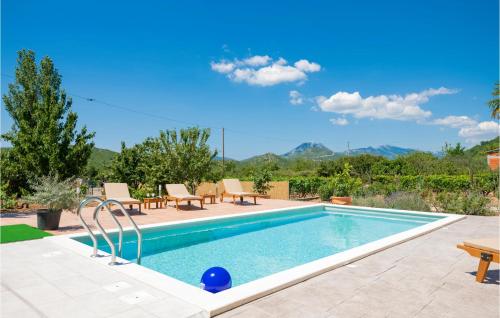 a swimming pool with tables and chairs next to at Three-Bedroom Apartment In Kresevo in Kreševo