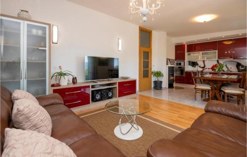 a living room with a couch and a glass table at Three-Bedroom Apartment In Kresevo in Kreševo