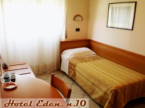 a hotel room with a bed and a table at Hotel Eden in Milan