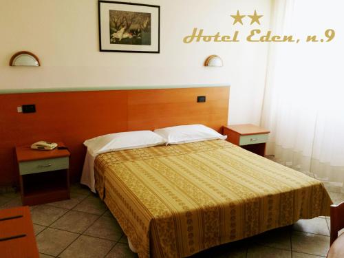 a hotel room with a bed and two night stands at Hotel Eden in Milan