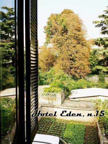 a window with a view of a tree at Hotel Eden in Milan