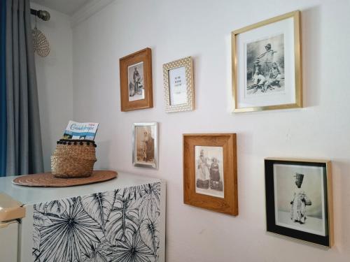 a wall with framed pictures on a wall at Suite 4 pers dans village vacances in Sainte-Anne