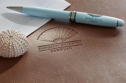 a pen sitting on top of a piece of paper at Mandarin Oriental, Canouan in Canouan