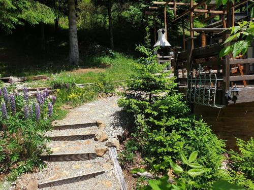 a garden with purple flowers and a walk way at AlmFerienhaus Gaisegg am Klippitztörl in Klippitztorl