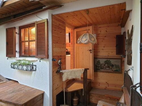 a wooden cabin with a door and a window at AlmFerienhaus Gaisegg am Klippitztörl in Klippitztorl