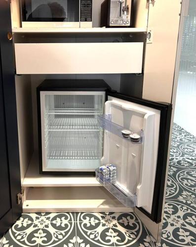 a refrigerator with its door open in a kitchen at Between the City and the Sea w/ King Size Bed in Perth