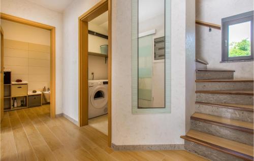 a laundry room with a washing machine and a staircase at 3 Bedroom Awesome Home In Divaca in Divača